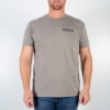 Light-gray t-shirt, front with  James Bean written on the left peck. Man is using the shirt.