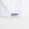 Close-up of the shirt’s tag. A white rectangle written “James B. Beam” in black.